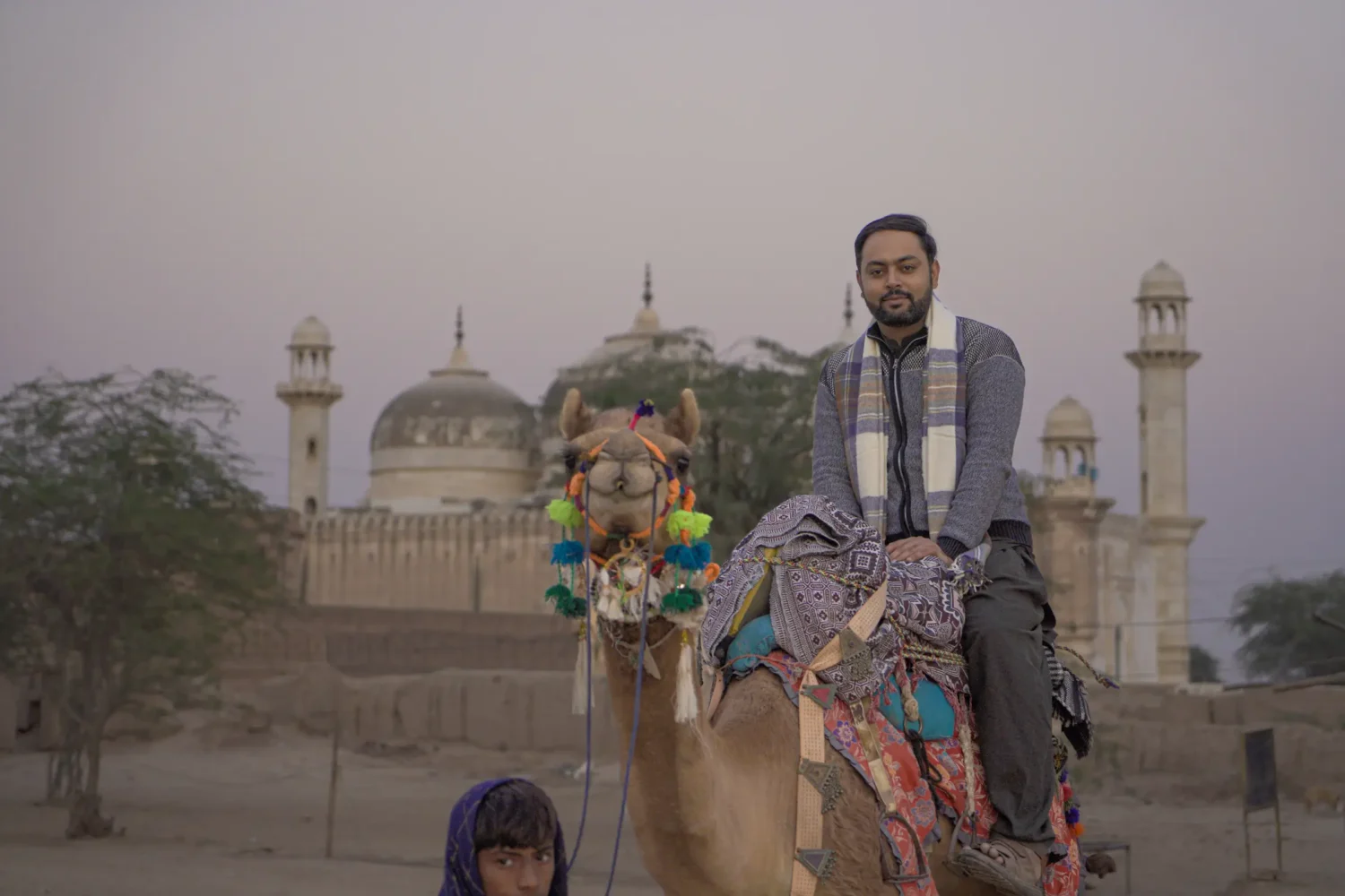 Tourist enjoying camel safari at Derawar